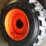 Set of Four (4) 10×16.5 Skid Steer Loader Tire with Orange Color Rims mounted, 14 PLY, NHS SKS 400