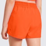 CRZ YOGA Girls Athletic Shorts with Zipper Pocket Lightweight Running Shorts for Teen Girls Kids Liner Neon Orange Medium